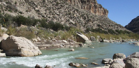 River running through a valley with rocks