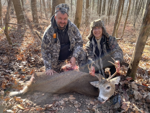 Mentor and Refuge Manager Mike Horne and Mentee Griffin pose with harvested buck during mentored archery deer hunt at Cherry Valley National Wildlife Refuge in November 2024