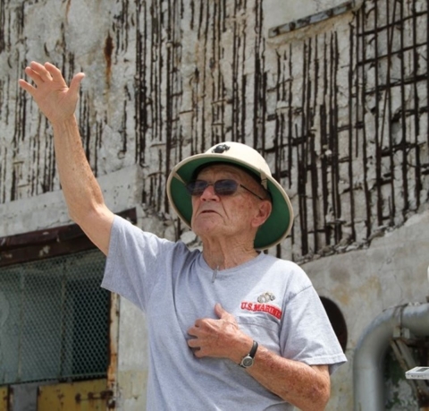 Veteran John F. Miniclier raises his hand explaining an episode of Battle of Midway 