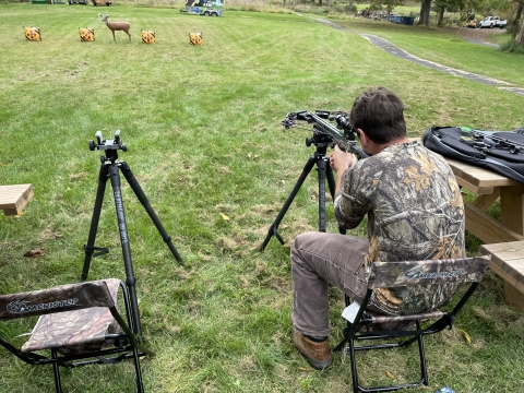 Mentee lines up his crossbow during archery practice at the Field to Fork mentored archery deer hunt at Cherry Valley National Wildlife Refuge in November of 2024