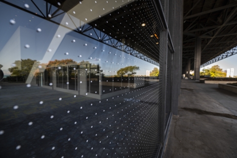 two inch dot pattern applied to windows along a large building