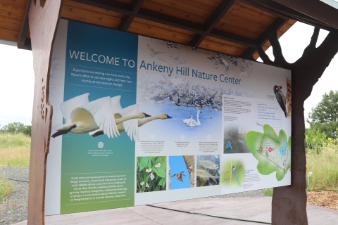 Interpretive Kiosk with information about the Ankeny Hill Nature Center with a map, Swans, native plants, dragonflies, an Acorn Woodpecker, and more