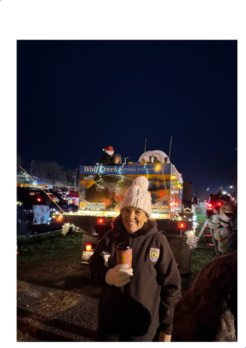 USFWS employee in front of decorated fish truck