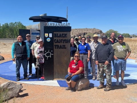 Fourteen people pose for a group photos at the Black Canyon trailhead at Pahranagat Refuge