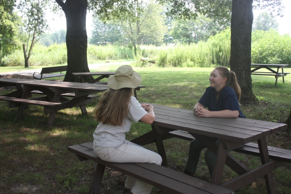 An image of two people at a picnic table.