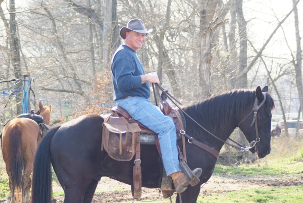 An image of a person riding a horse.