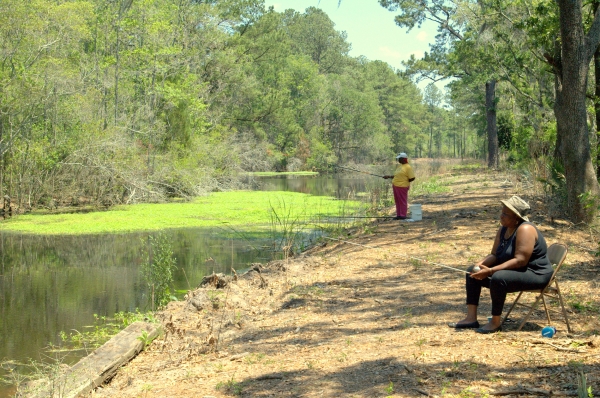 Two women fish off of a bank at E.F.H. ACE Basin NWR