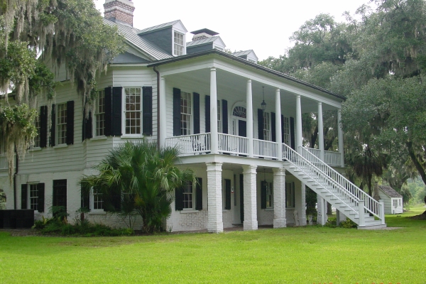 Grove Plantation Manor with small kitchen house in background.