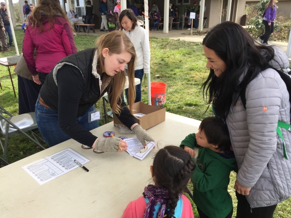 A volunteer at the annual Winter Wildlife Field Day event welcomes guests