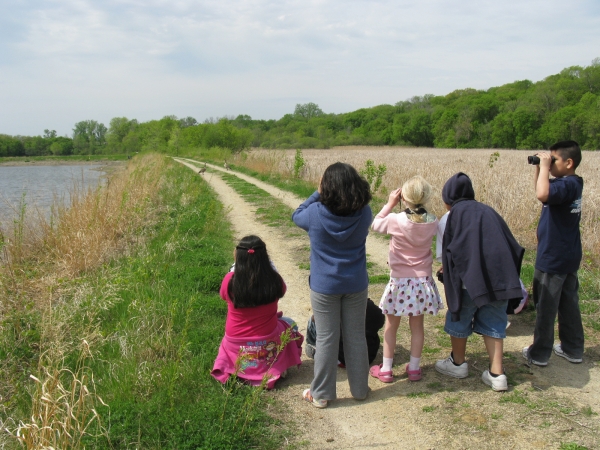 Group of five kids birdwatching 