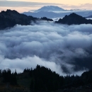 Fog-filled valleys looing toward a distant mountain