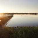 A rising sun shines on a new fishing pier at Detroit River International Wildlife Refuge.