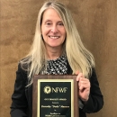 Person holding an award plaque.