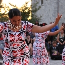 three American Samoa students performing a traditional dance in a circle