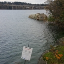 Shoreline with a posted warning sign reading "do not enter"