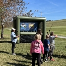 Kids shooting archery at a blow up target