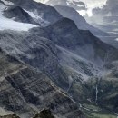 Sloped mountains rise from a river valley.