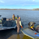 Biologists load boat full of invasive carp onto trailer.