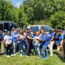 group stand outside, many wearing Zeta blue