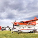 Migratory Bird Program Daher Kodiak survey plane in front of the International Federal Pavilion at EAA AirVenture convention