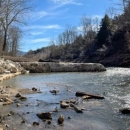 Three images of the dam. 1. Full dam on a rocky stream, 2. Partial dam, part of the structure is gone, 3. open river bed and earthen streambanks held in place with canvas and rock.