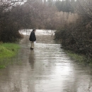 man standing on a flooded road