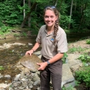 USFWS employee holding softshell turtle in stream