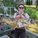 Employee holding a large fish.