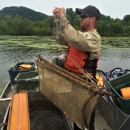 Person holding up net while on boat.