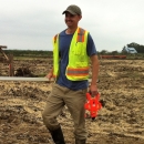 Bill Bennett walking through field.