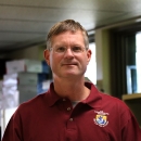 man in a lab with a fws logo on his shirt