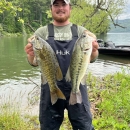 Colt Brewer holding two bass