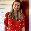 Hilary smiling in a red blouse