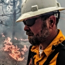 Jeffrey in front of ground level prescribed burn