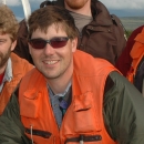 Man wearing orange safety float vest