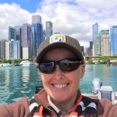 Woman smiling on boat in the Chicago river.