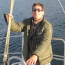 man standing on the deck of a boat