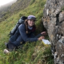 Sabrina points at an Aleutian Shield Fern in the field on Adak Island.