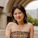 Celeste Chen stands in front of an archway and smiles for the camera