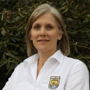 Headshot of Kyla Hastie - a blonde Caucasian woman - outside wearing a shirt with a Fish and Wildlife Service emblem