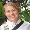 Close-up of a blonde woman smiling and wearing a white collared shirt with the U.S. Fish and Wildlife Service.