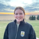 biologist in black jacket in front of sunset