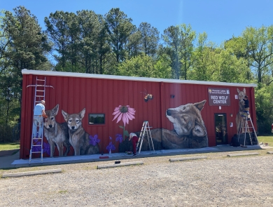 a large red building with animals on it