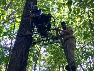 Fish and Wildlife Service employees repairing deer stand