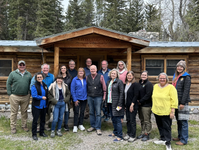 Image of group in front of cabin