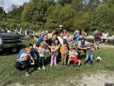 Group of kids smiling in front of stream