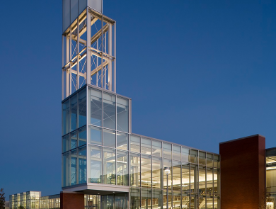 A building on a college campus illuminated by light at dusk