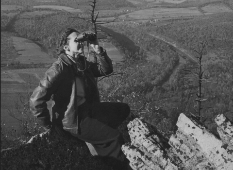 Rachel Carson sitting on mountain cliff