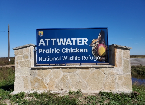 a sign with text "attwater prairie chicken national wildlife refuge"