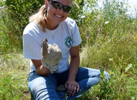 YCC staff sitting on hillside smiling at camera 